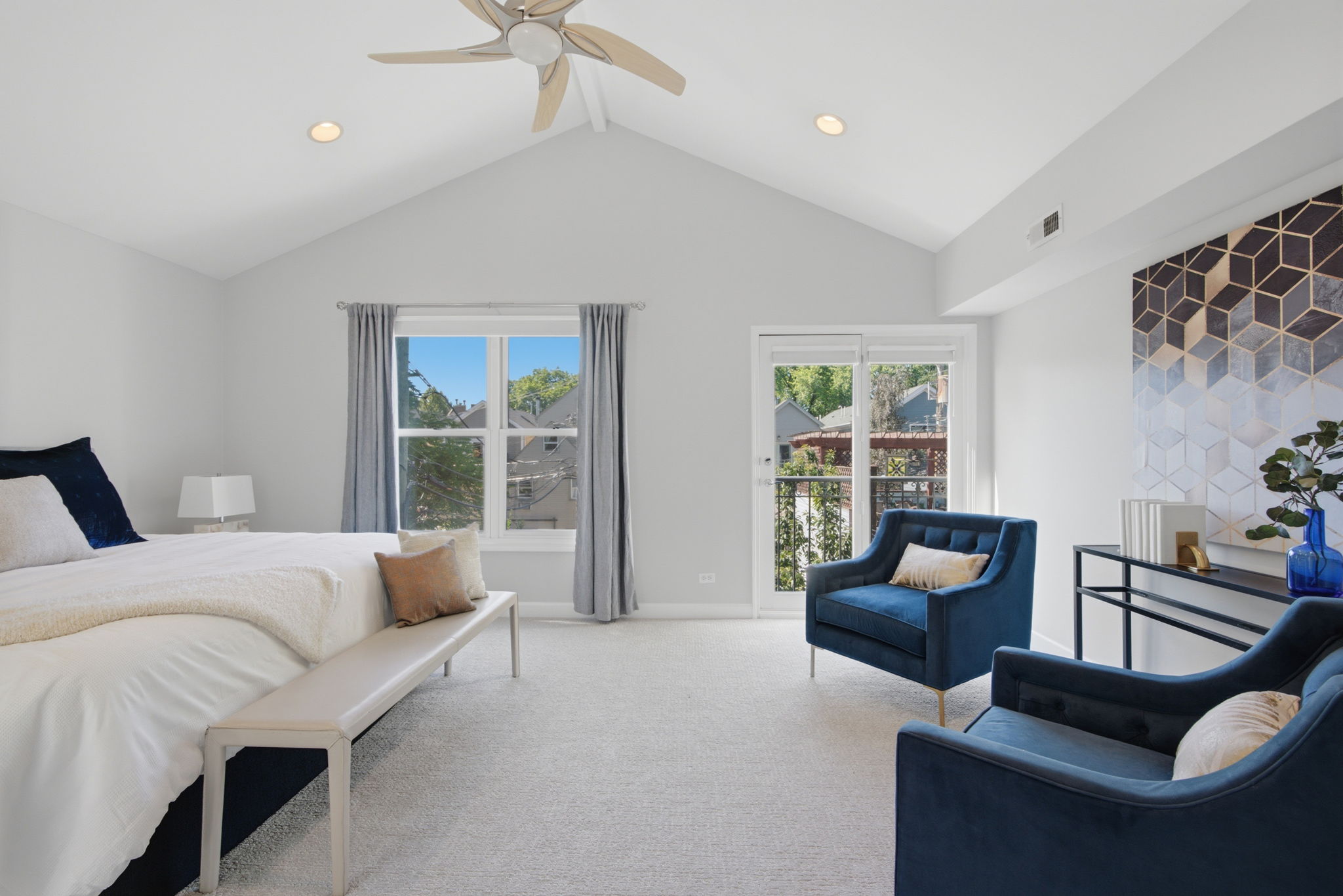Primary bedroom with vaulted ceiling